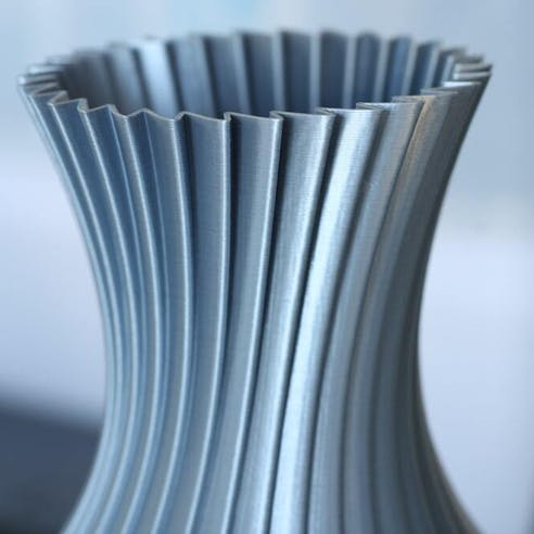 Metallic silver 3D printed vase. Image Credit: Shutterstock.com/Slimprint