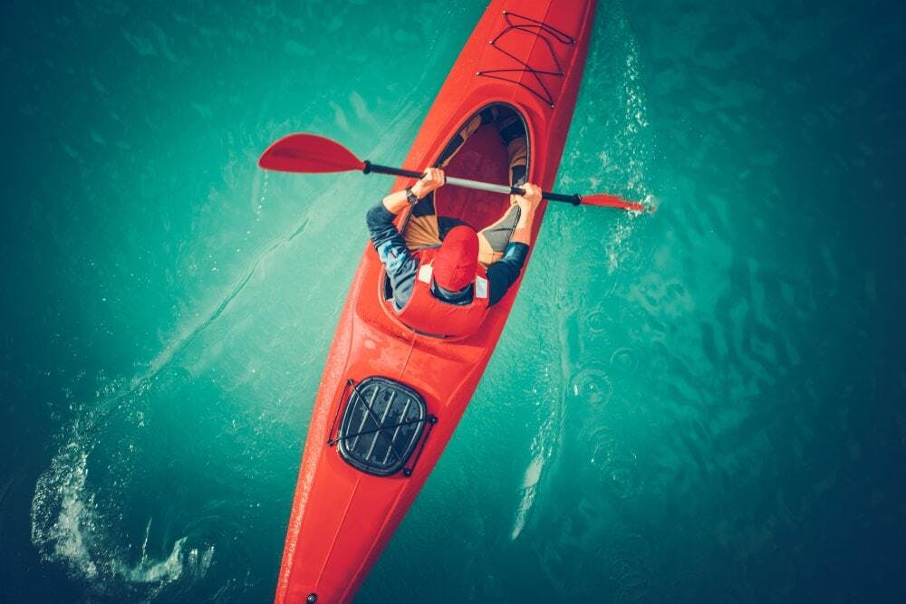 red kayak in body of water