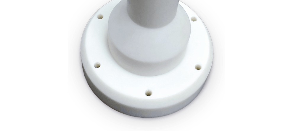 Image of a cylindrical part machined out of white plastic.