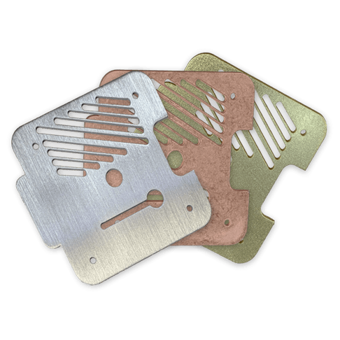 An array of sheet metal parts of different materials and finishes.