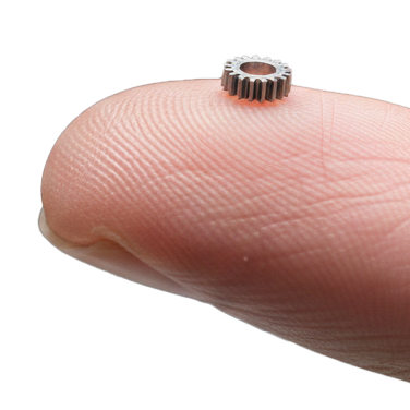 A micro-machined part sitting on a fingertip.