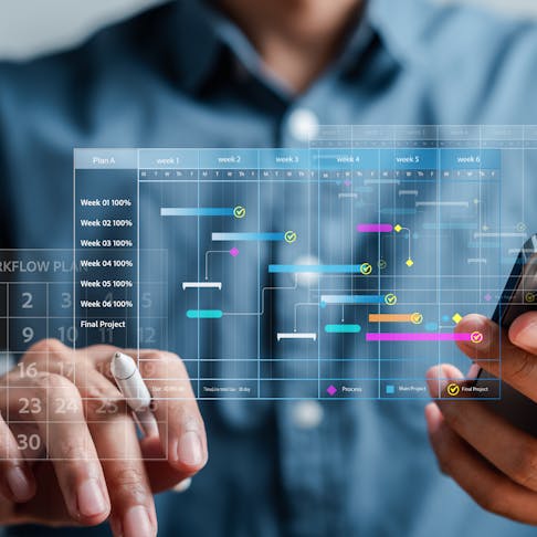 Closeup of hands holding a phone with an overlay of a calendar and scheduling program