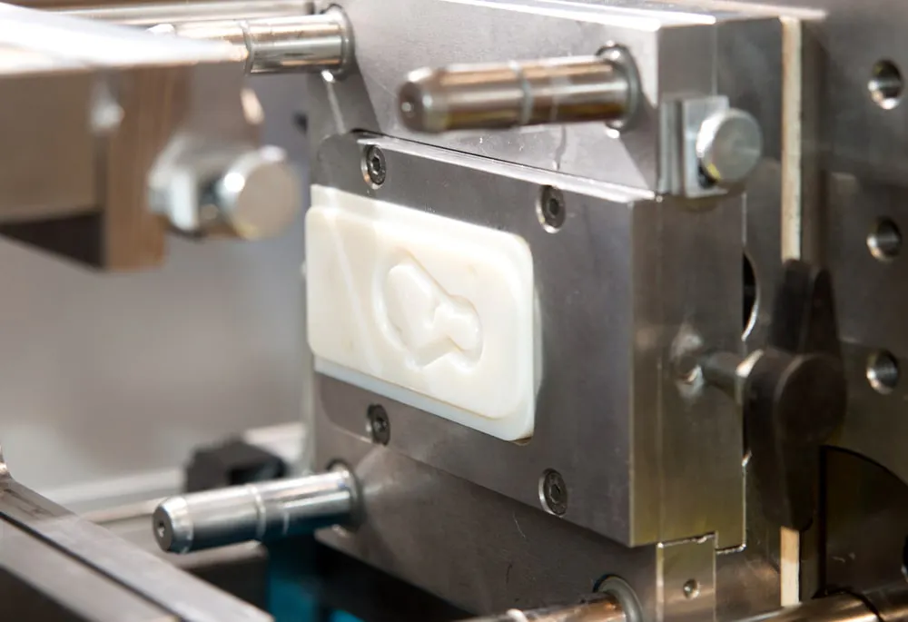 A small mold inserted into an injection molding machine. Image Credit: Shutterstock.com/Moreno Soppelsa