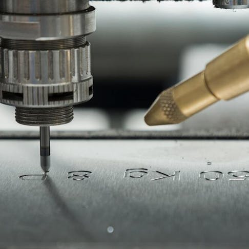 Laser engraving on metal sheet. Image Credit: Shutterstock.com/szelltib