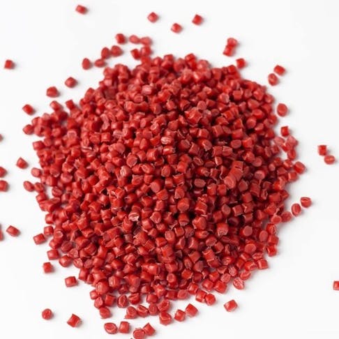 Red polypropylene granules on a white background. Image Credit: Shutterstock.com/Anastasiia Burlutskaia