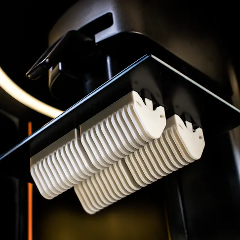 MPU 100 parts attached to build platform of Carbon DLS machine.