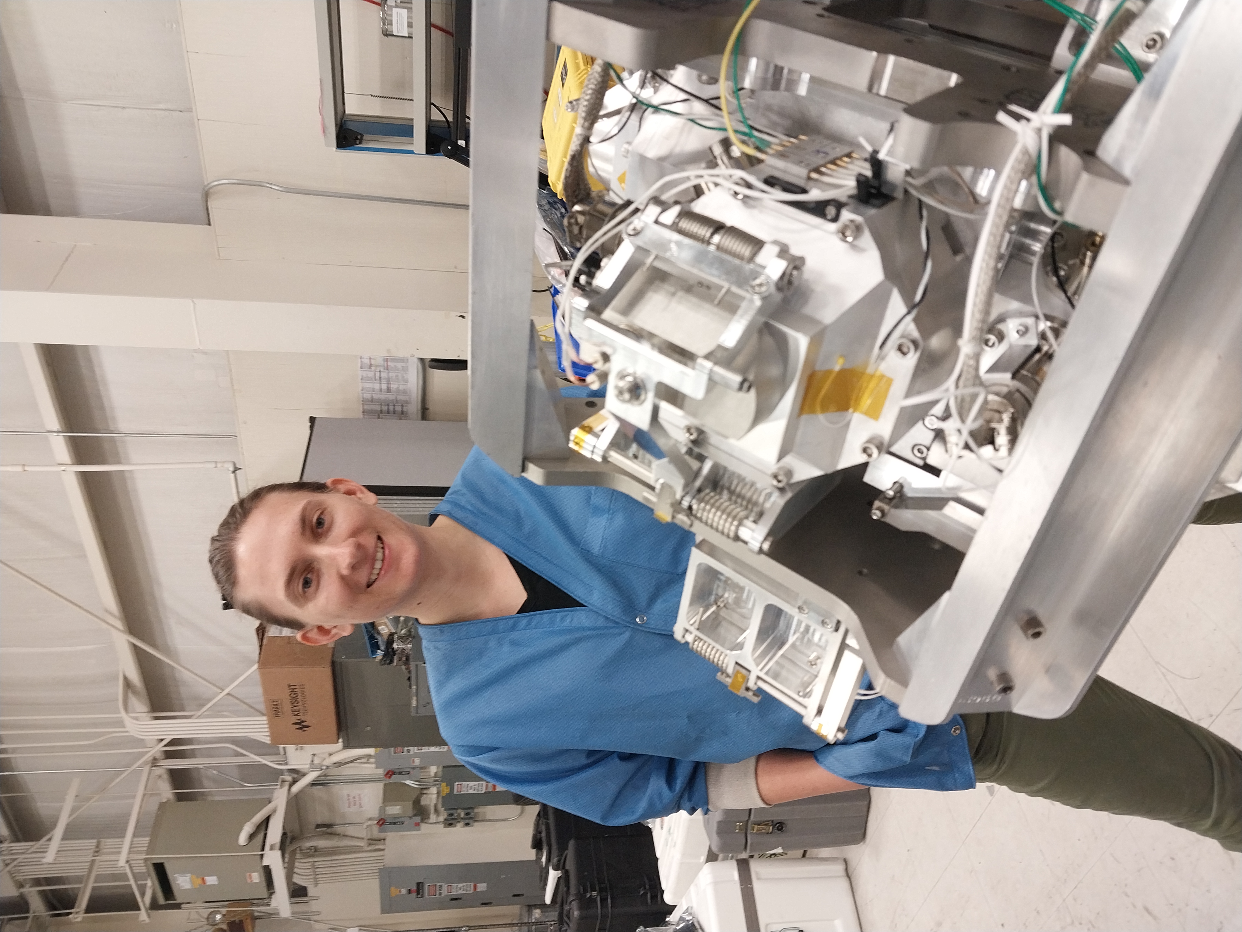 UNH physics graduate student Diana Swanson poses with the ion gauge mounted on the RENU3 rocket.