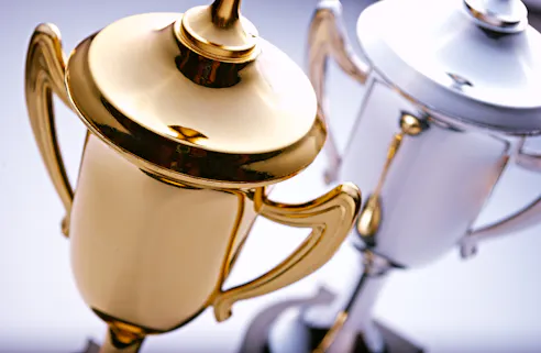 Gold and silver trophies. Image Credit: Shutterstock.com/Sergii Gnatiuk