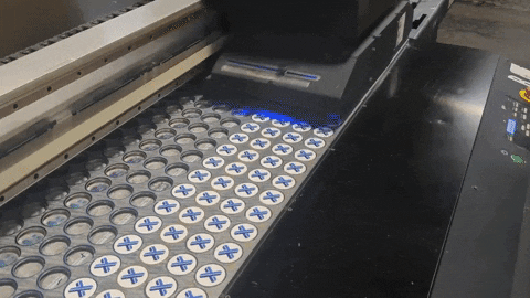 the Xometry brand logo being printed on hundred of Pop-Grips