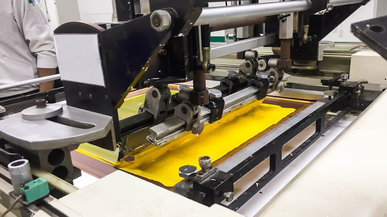 A screen printing machine in operation.