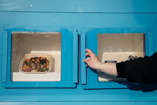 a photo of a customer collecting their food from the Mezli locker - Photo by Allison Busch, courtesy of Mezli.