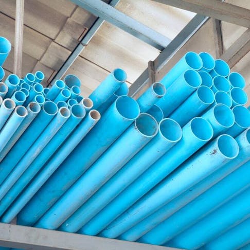 A pile of blue PVC pipes. Image Credit: Shutterstock.com/Winai Tepsuttinun