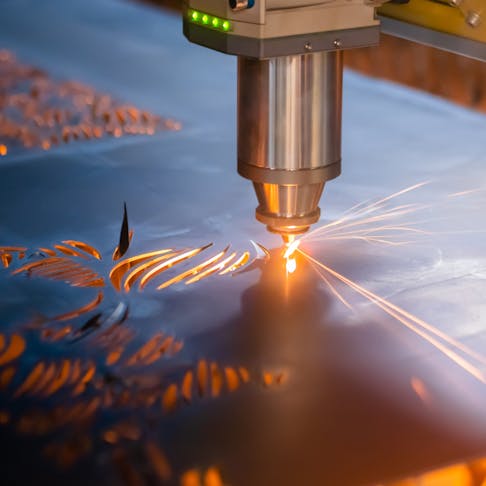 Laser cutter working on metal sheet. Image Credit: Shutterstock.com/Zyabich