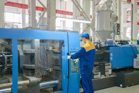 Industrial injection molding press machine. Image Credit: Alba_alioth/Shutterstock.com