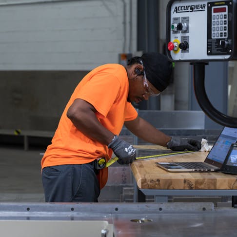 Partner working in shop on sheet metal project