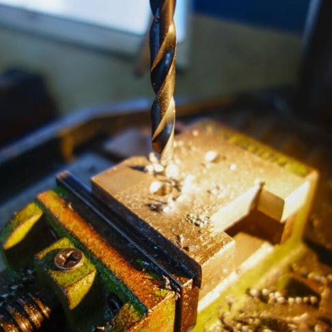 Counterbore hole drilling in a metal workshop. Image Credit: Shutterstock.com/arfa adam