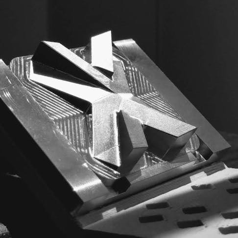 finished Xometry X logo in metal