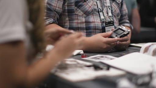 an attendee examaning their smart badge