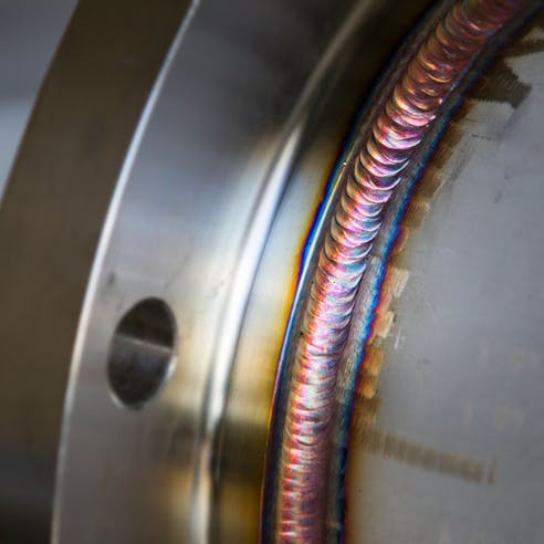 Steel weld joined pipe to plate by arc welding process. Image Credit: Shutterstock.com/22August