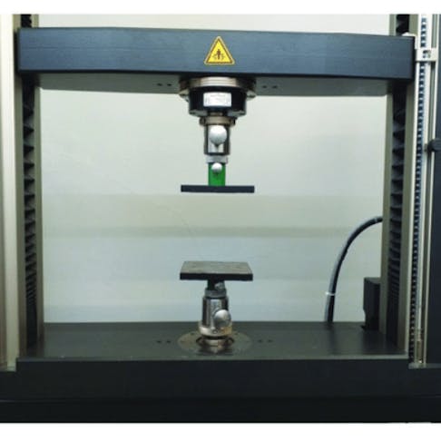 Edge crush testing apparatus. Image Credit: https://www.researchgate.net/figure/Instrumentation-for-the-edge-crush-test-ECT-a-measuring-instrumentation-b-test_fig2_340485658