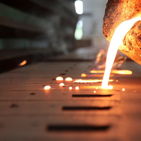 Pouring molten metal for casting. Image Credit: Shutterstock.com/Mr.1