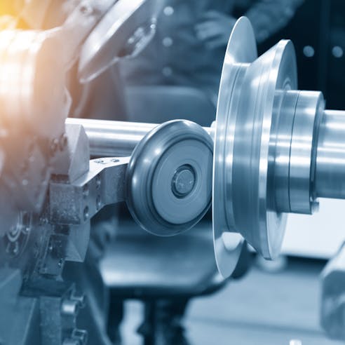 CNC spinning machine forming an aluminum plate. Image Credit: Shutterstock.com/Pixel B