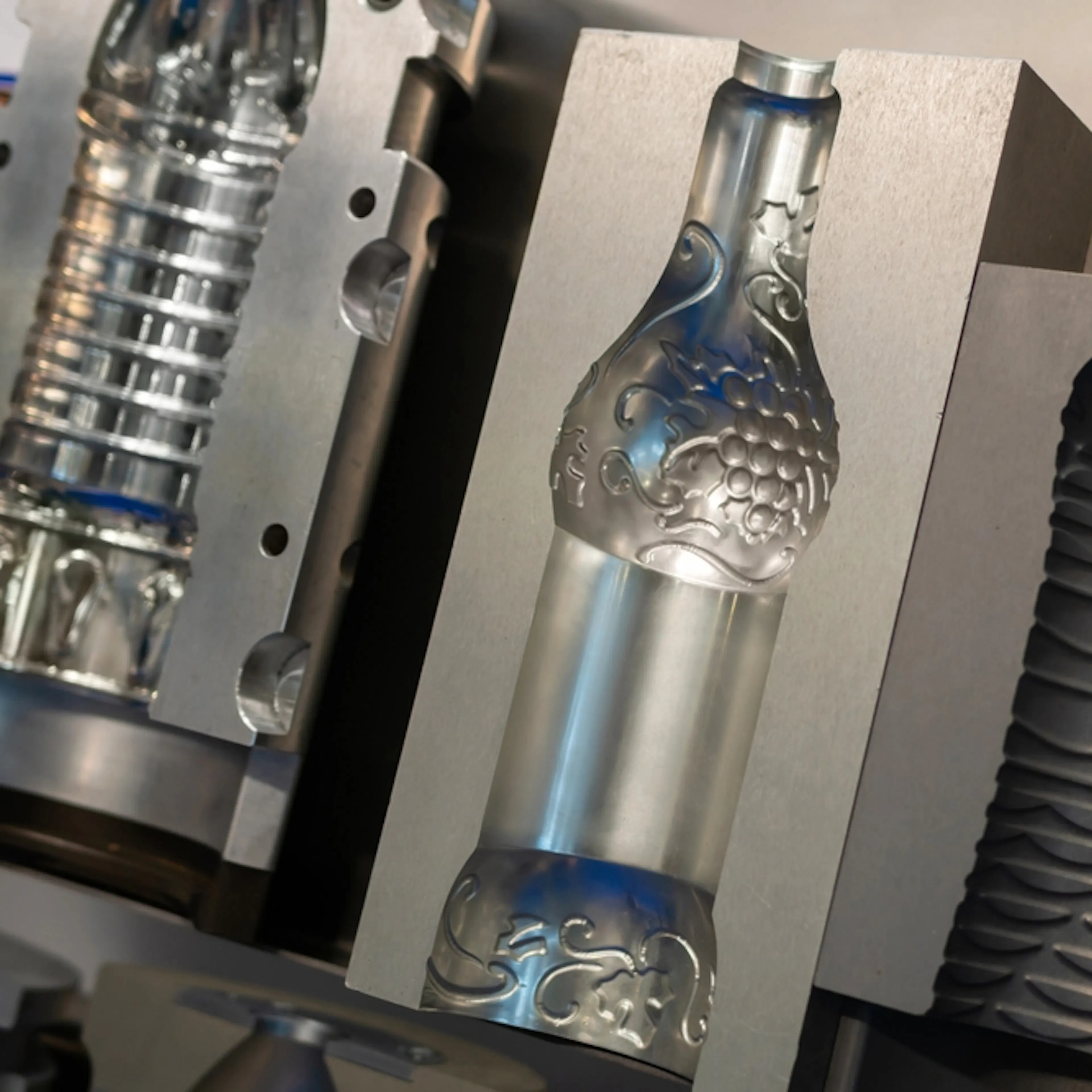 PET bottles being produced in a blow molding machine. Image Credit: MOLPIX/Shutterstock.com