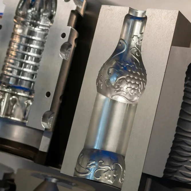 PET bottles being produced in a blow molding machine. Image Credit: MOLPIX/Shutterstock.com