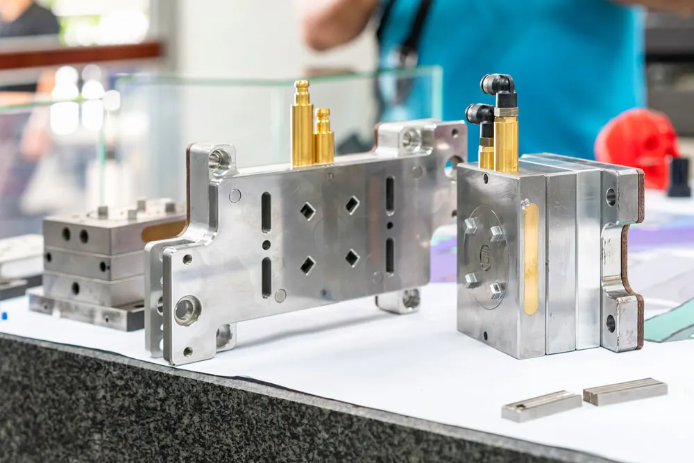 Injection mold with cooling hose. Image Credit: Surasak_Photo/Shutterstock.com