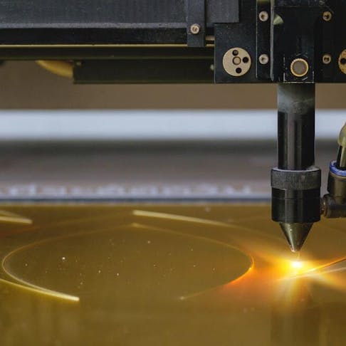 Laser cutting on plastic board. image Credit: Shutterstock.com/John99