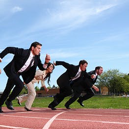 a line of professionals ready to sprint on a track field