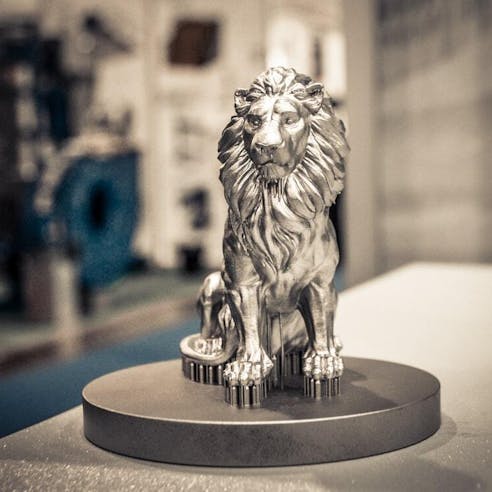 Bronze lion sculpture. Image Credit: Shutterstock.com/MarinaGrigorivna