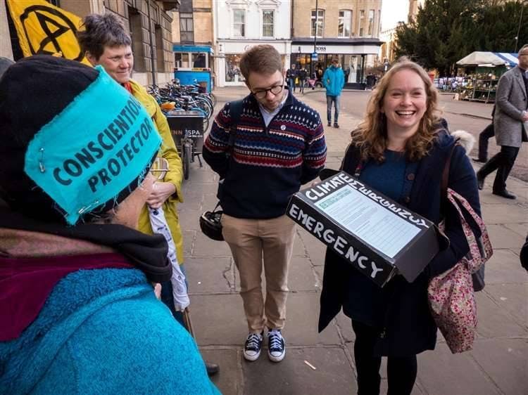 Cllr Rosy Moore receiving the XR petition asking council to declare climate emergency, 2019. Credit: Derek Langley