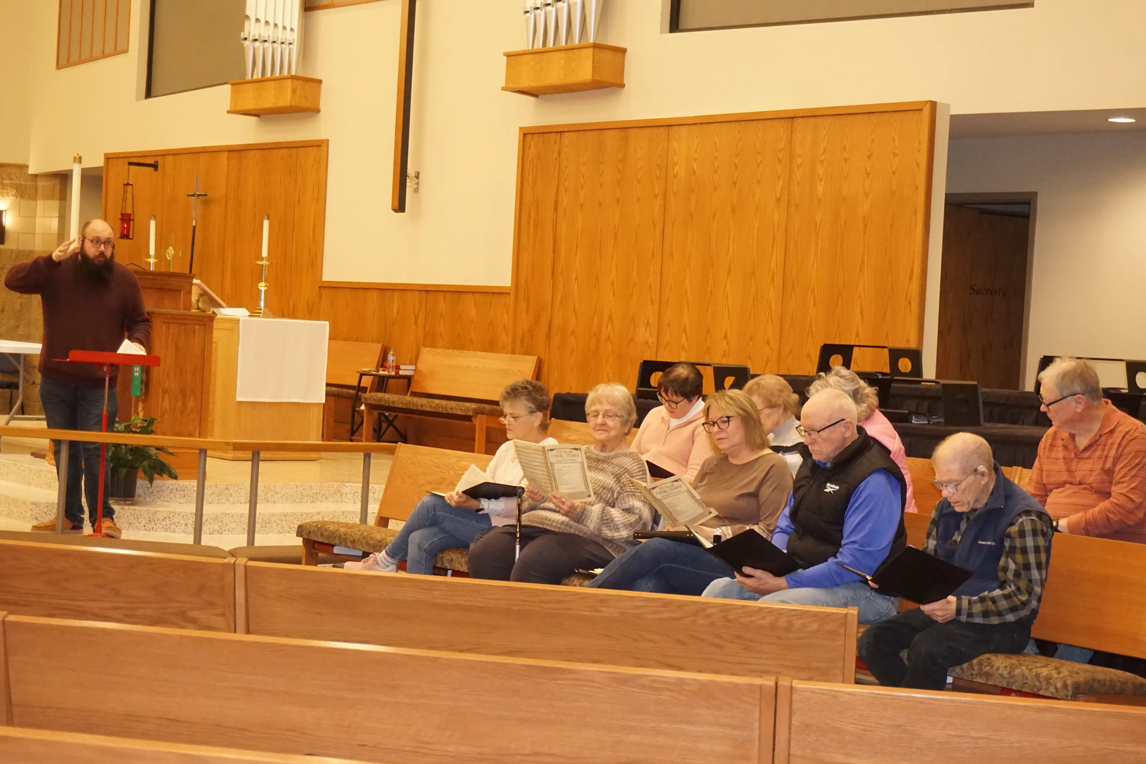 Choir learning songs at practice.