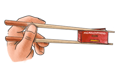 Hand holding chopsticks with microlearning sushi