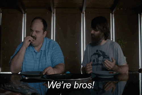 Gif of a man holding his fist out to bump with caption "We're bros!"