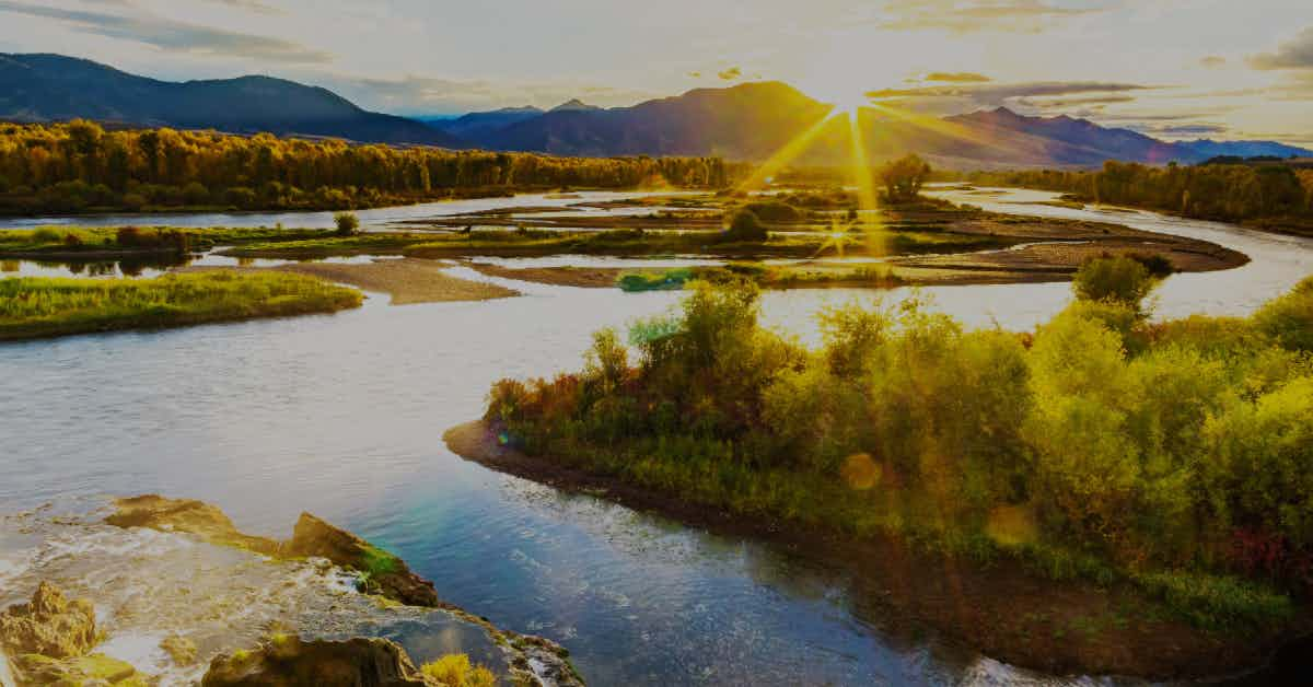 The sun rises over Swan Valley, ID and the South Fork of the Snake River.