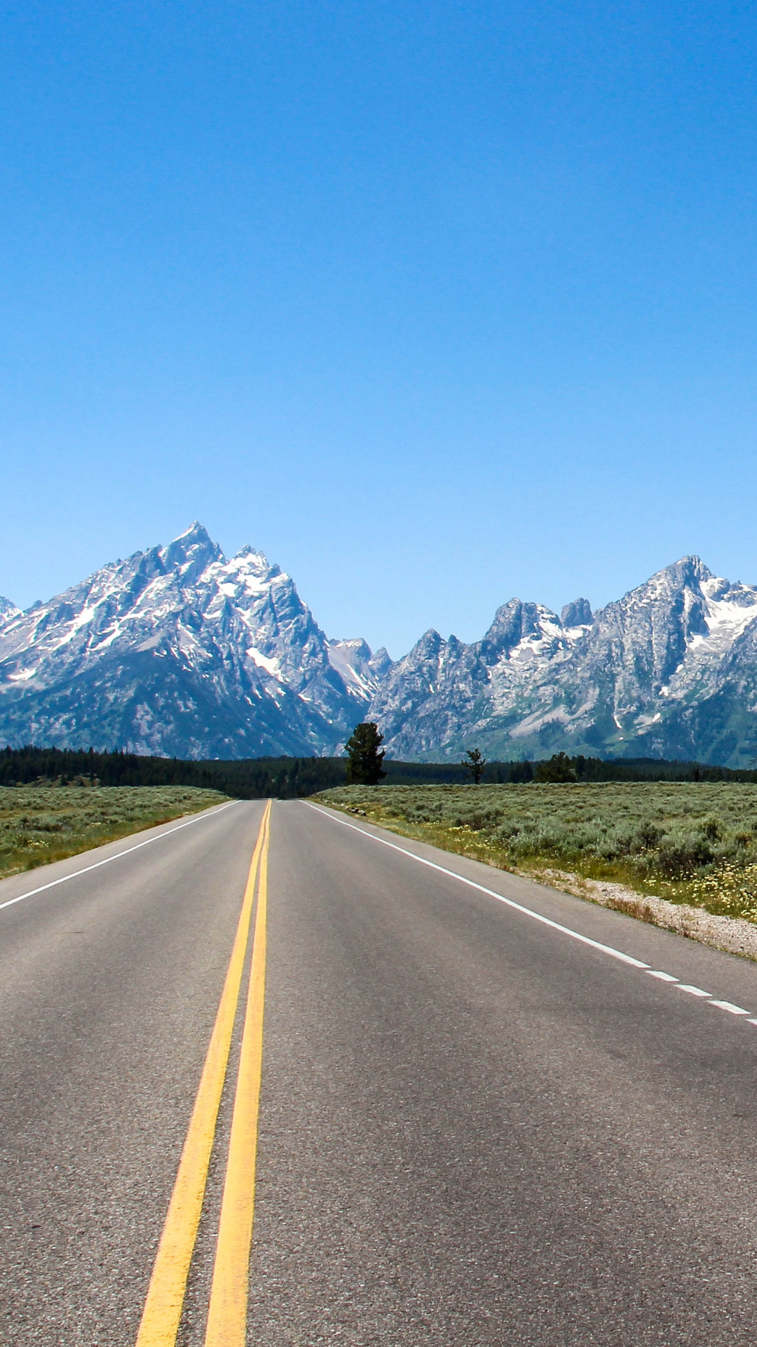 Road view headed towards the Teton Mountains and Grand Teton National Park.