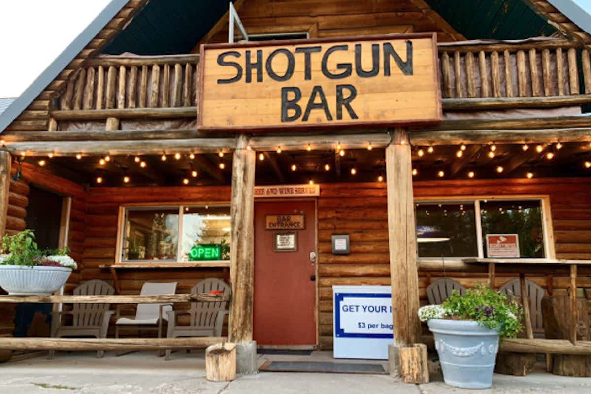 Outside view of the Shotgun Bar in Island Park, Idaho of the Yellowstone Teton Territory, offering a rustic atmosphere and friendly staff.