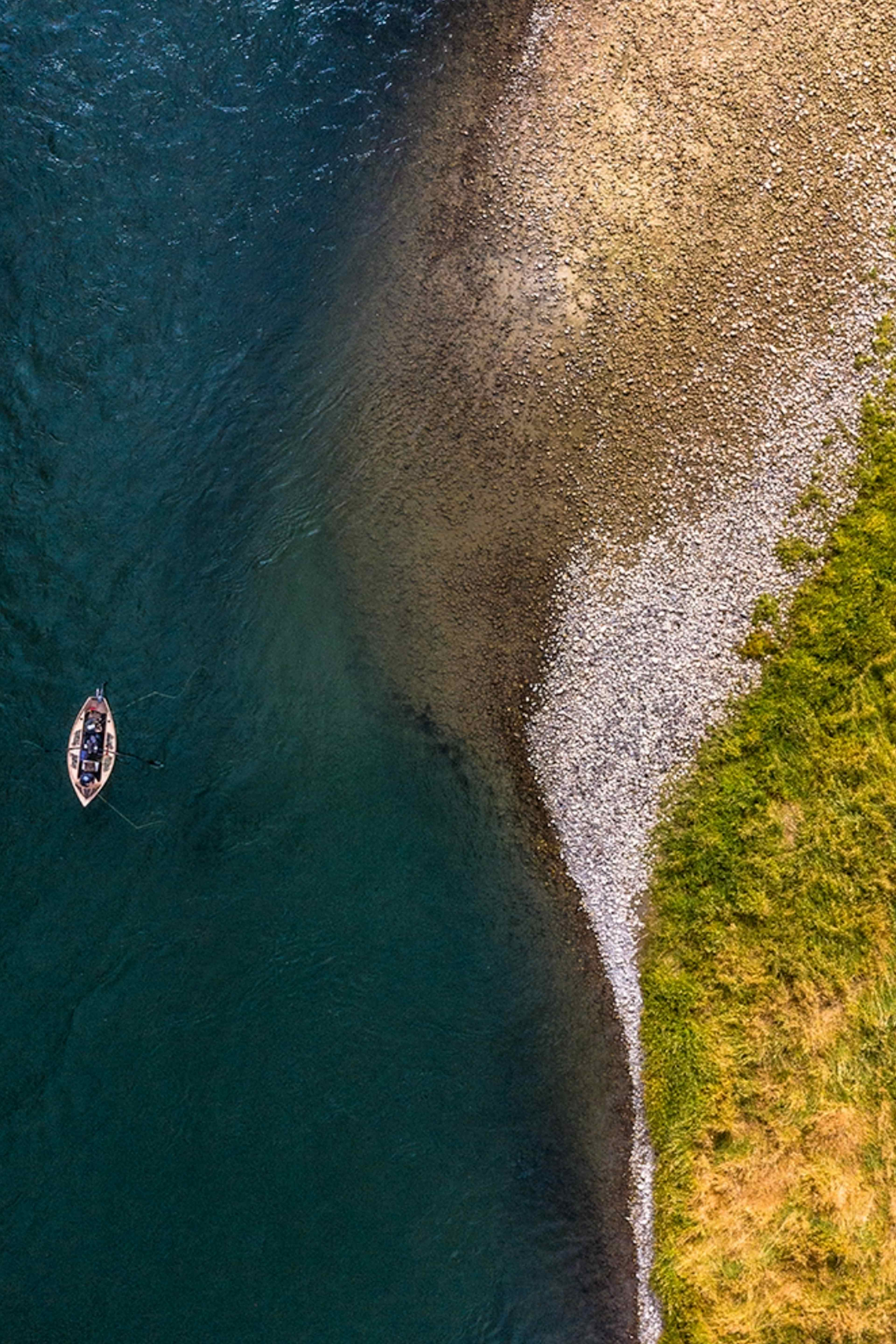 Aerial view of fishermen and boat on the South Fork of the Snake River at Palisades Dam in Swan Valley, Idaho.