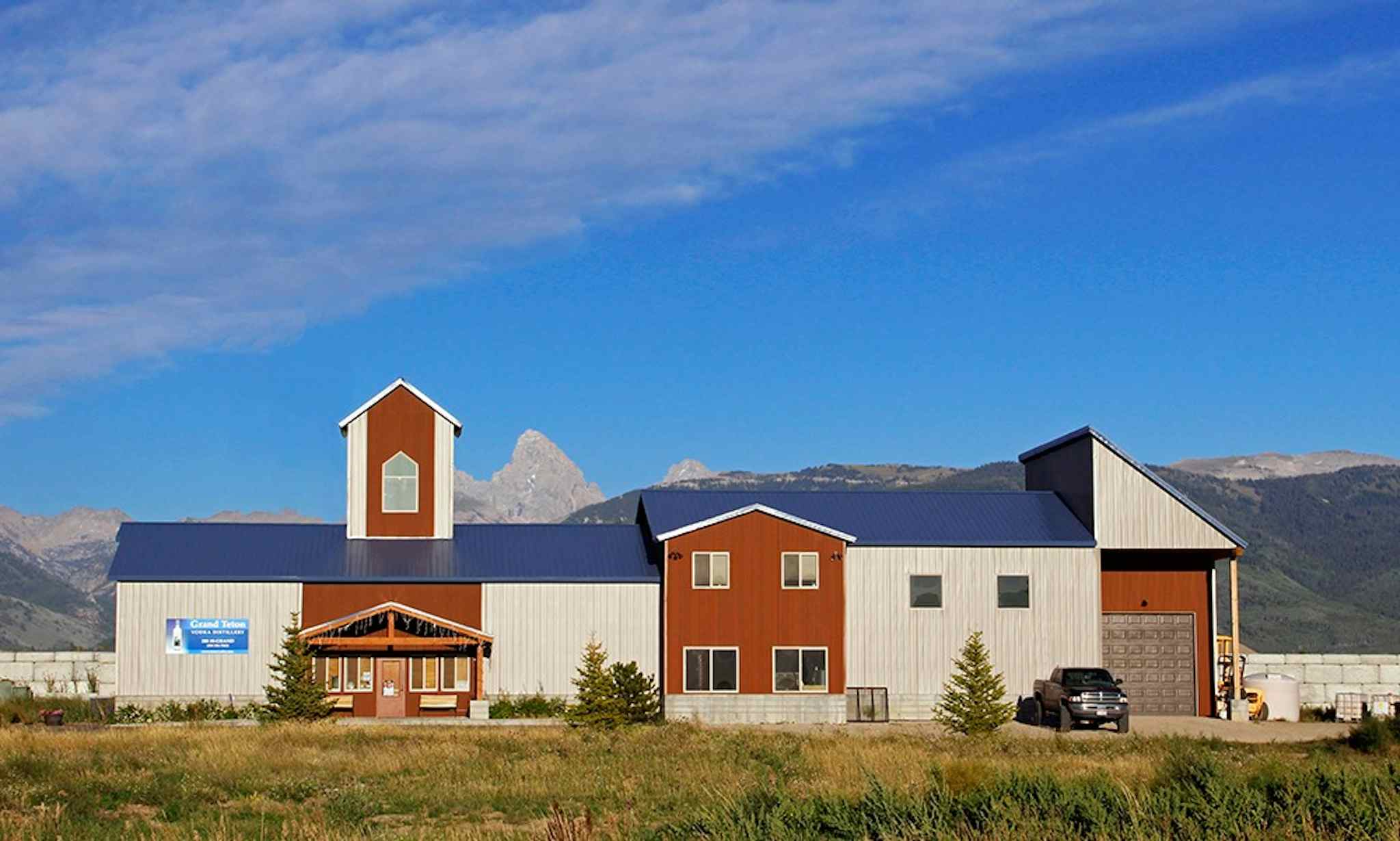 Outside view of the Grand Teton Distillery, with a beautiful view of the mountains from which the business gets its name