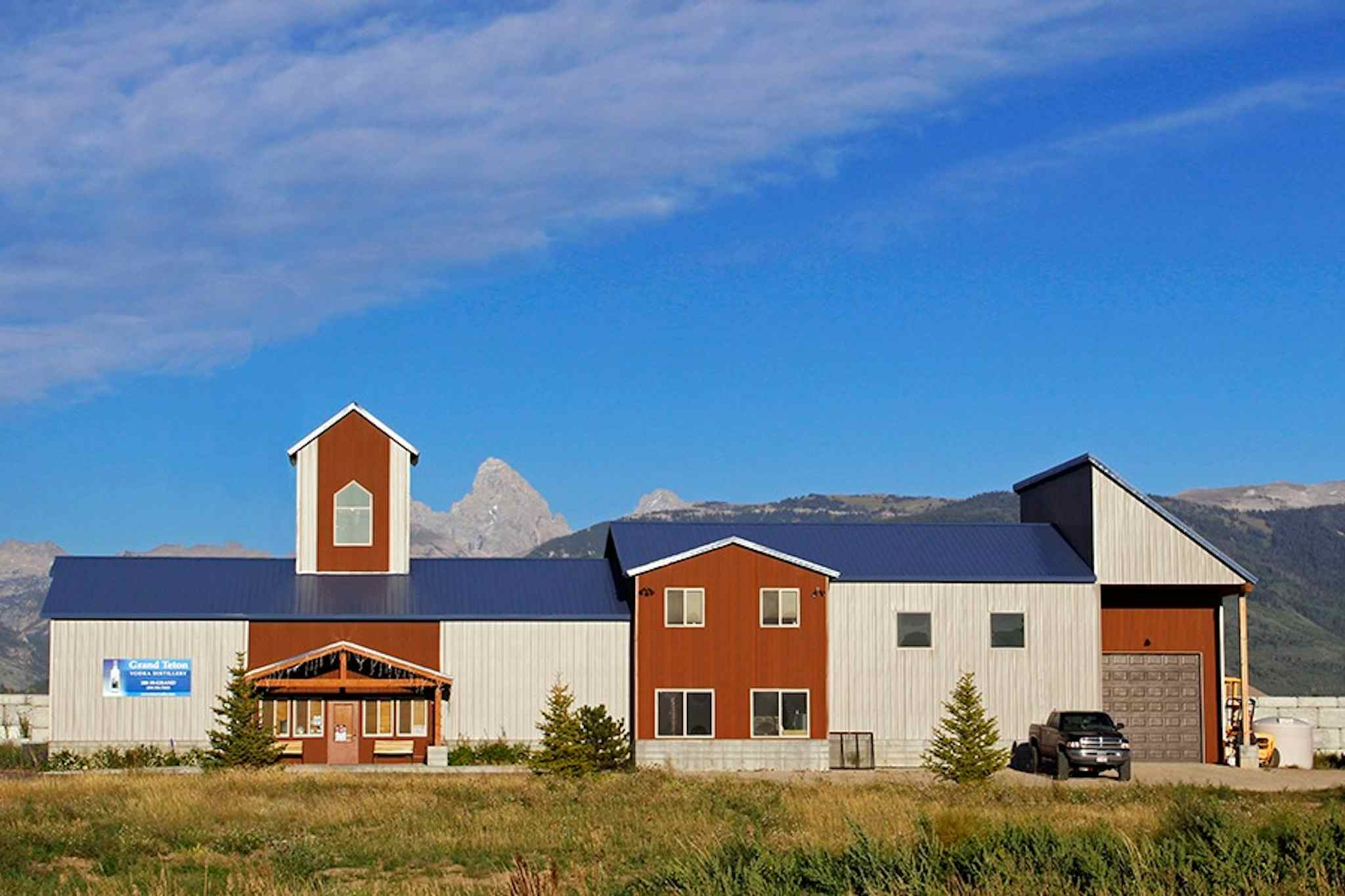 Outside view of the Grand Teton Distillery, with a beautiful view of the mountains from which the business gets its name