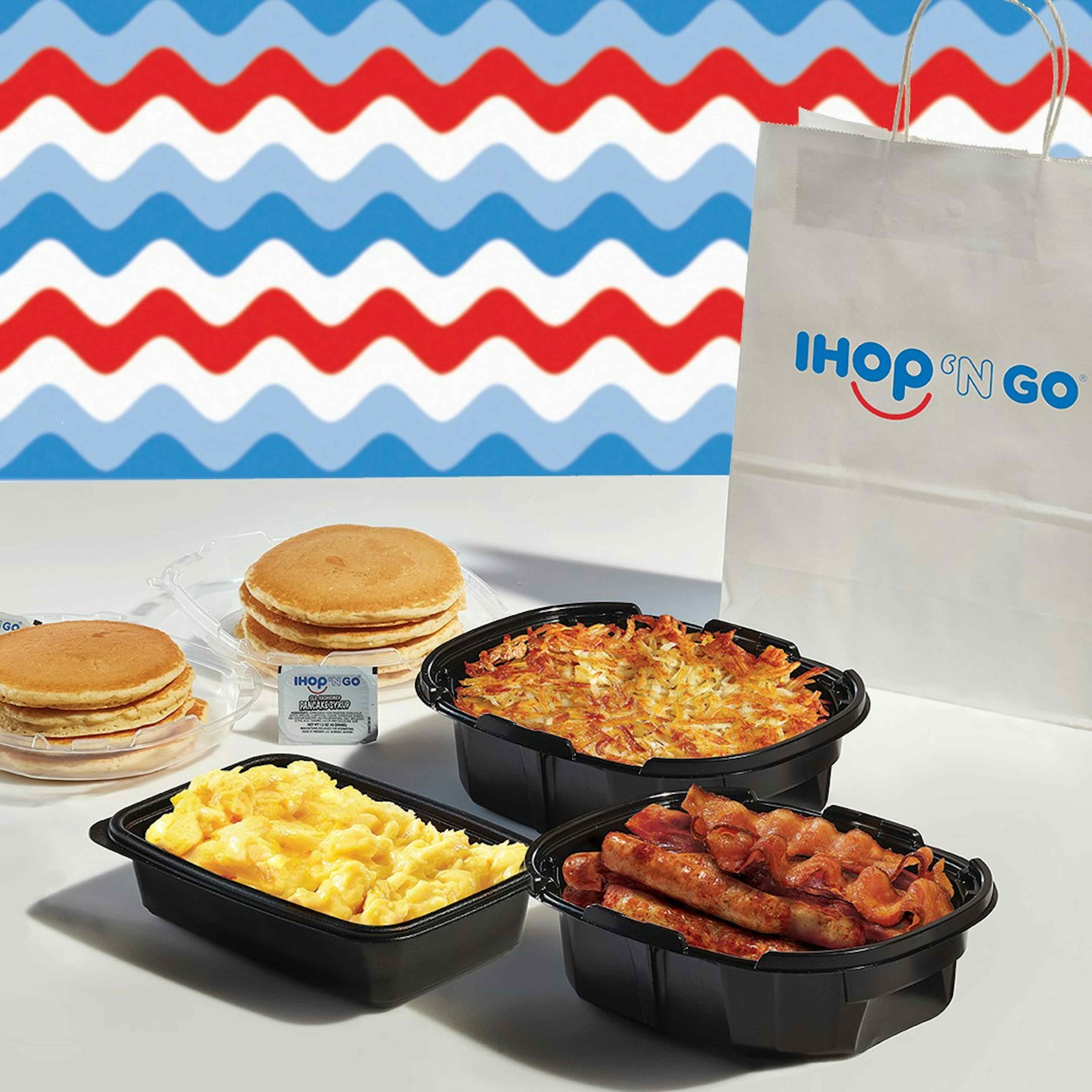 To-go options offered at IHOP of Ammon within the Yellowstone Teton Territory, featuring hashbrowns, bacon and sausage, pancakes, and scrambled eggs. 