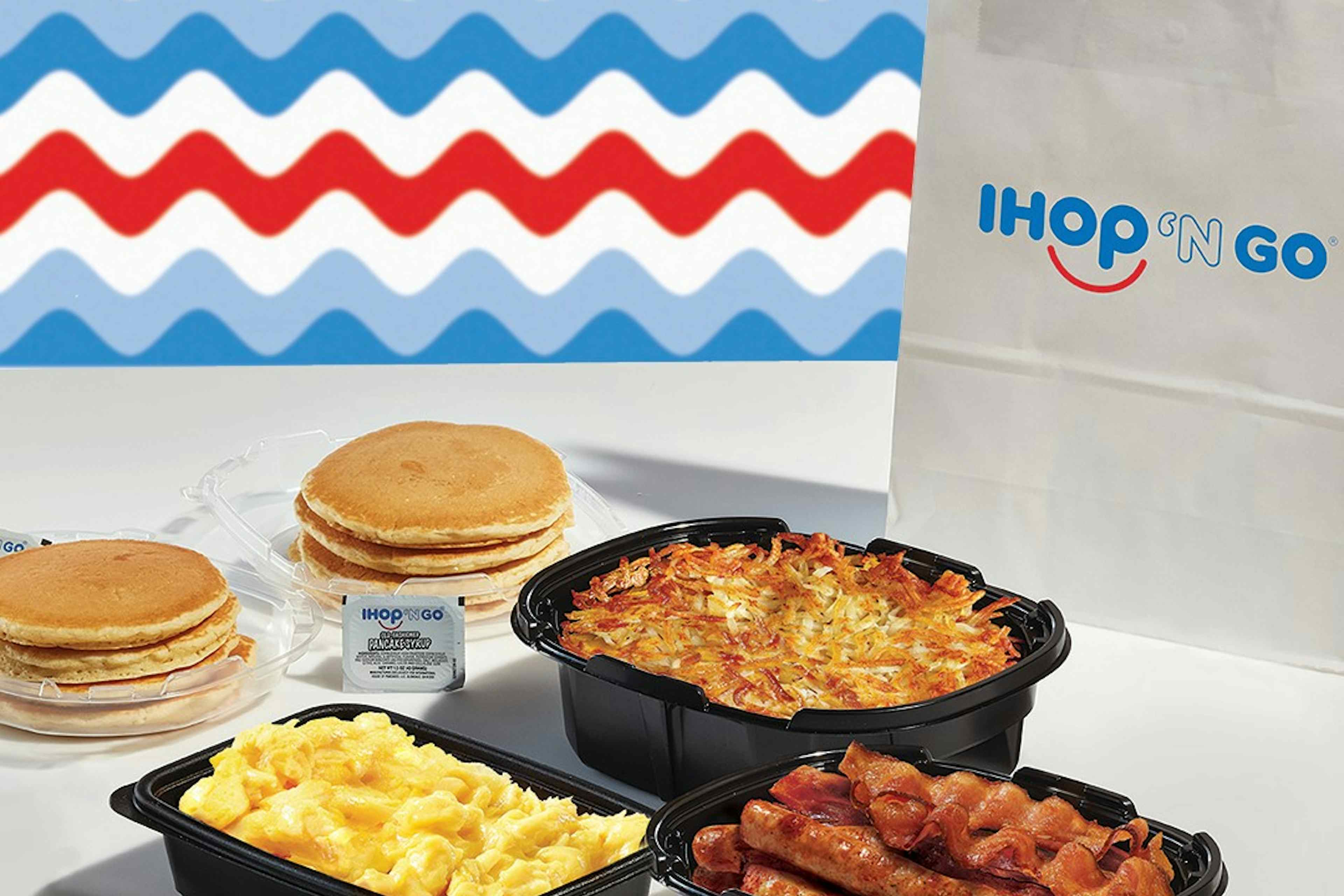 To-go options offered at IHOP of Ammon within the Yellowstone Teton Territory, featuring hashbrowns, bacon and sausage, pancakes, and scrambled eggs.