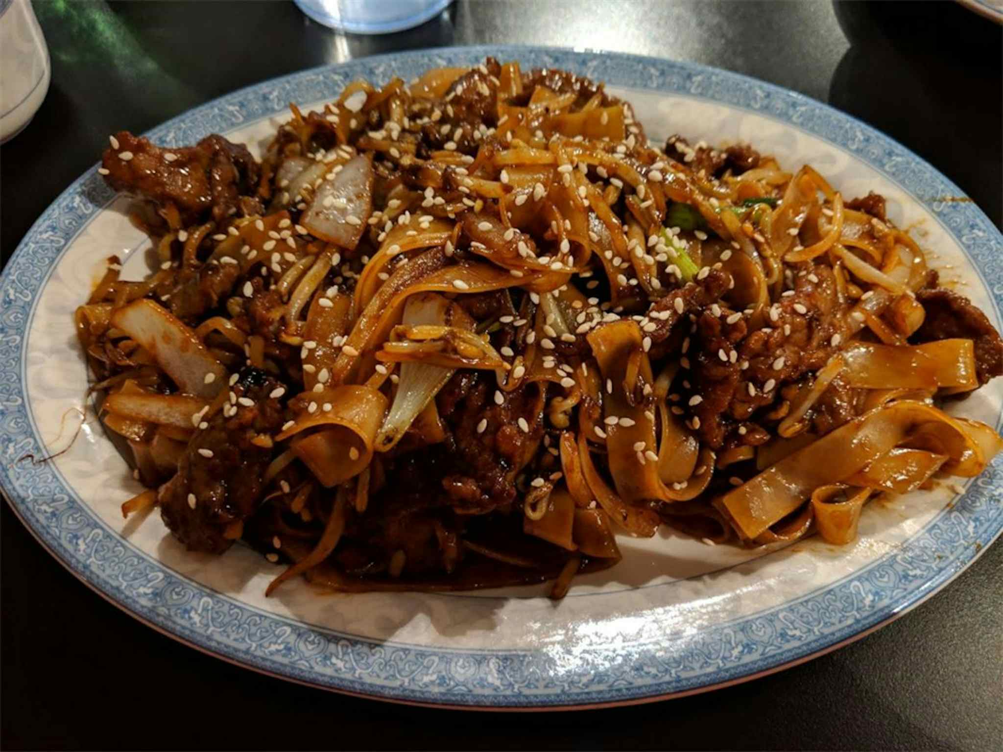 Glassy noodles with cabbage and chicken, topped with sesame seeds and served at the Chinese Garden Restaurant of Idaho Falls in the Yellowstone Teton Territory. 