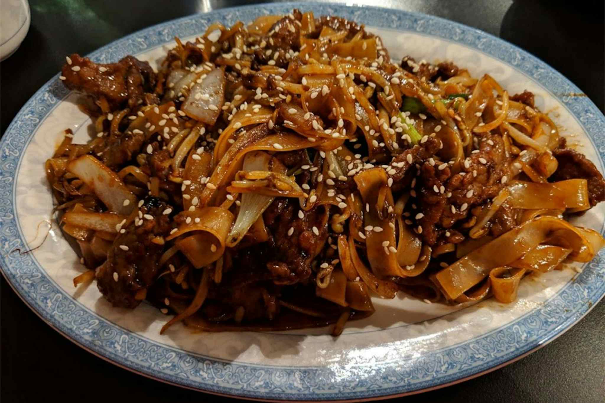 Glassy noodles with cabbage and chicken, topped with sesame seeds and served at the Chinese Garden Restaurant of Idaho Falls in the Yellowstone Teton Territory.