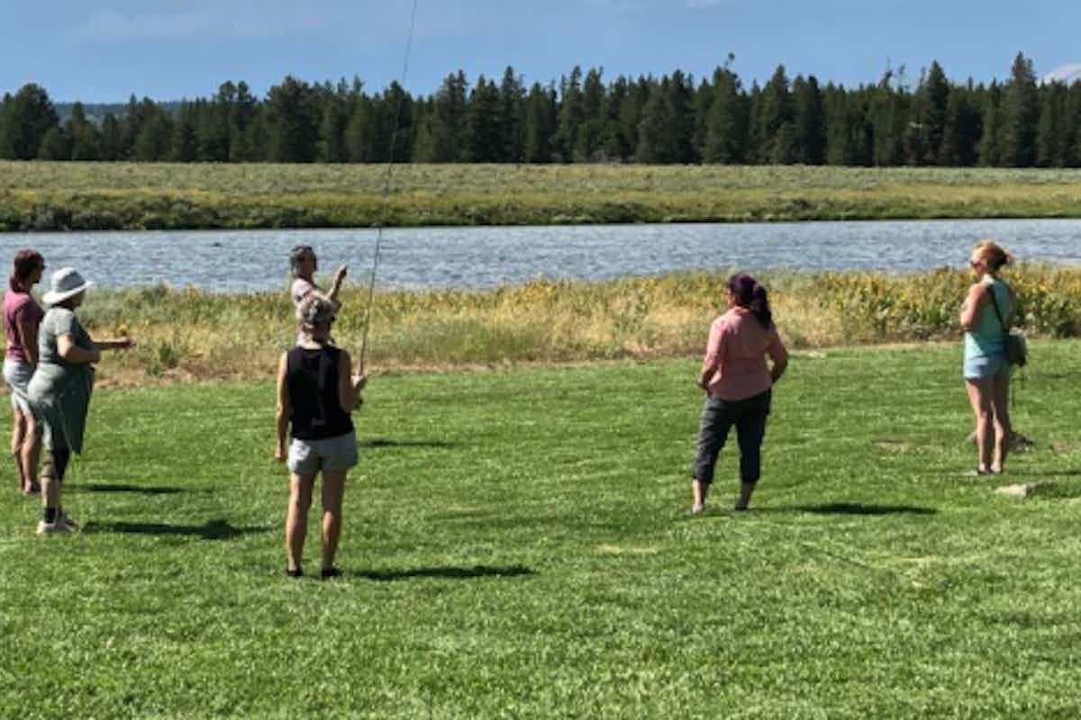 Women practice fly fishing next to the Henry's Fork of the Snake River.