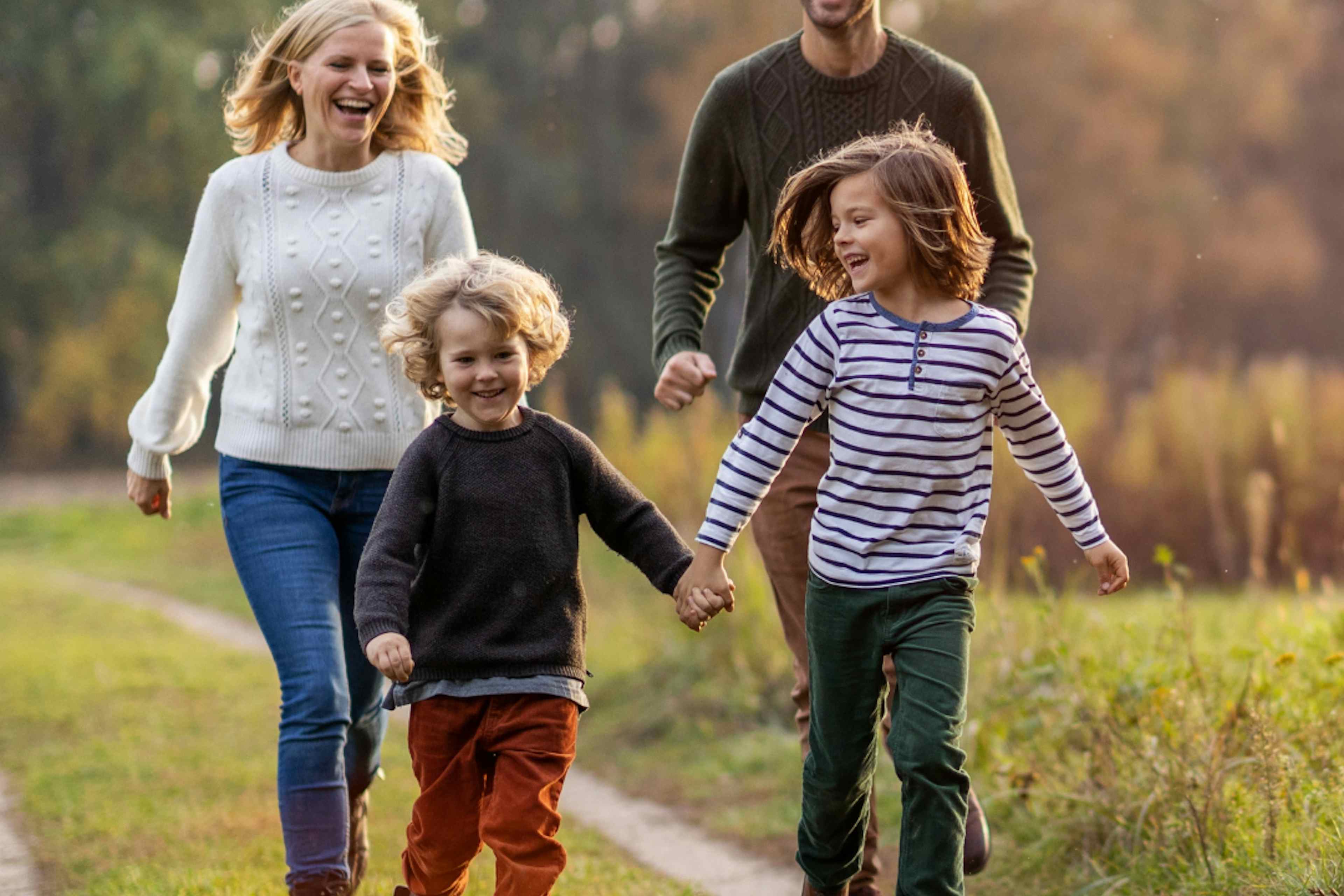 Family runs in municipal park in Rexburg Idaho within Yellowstone National Park.