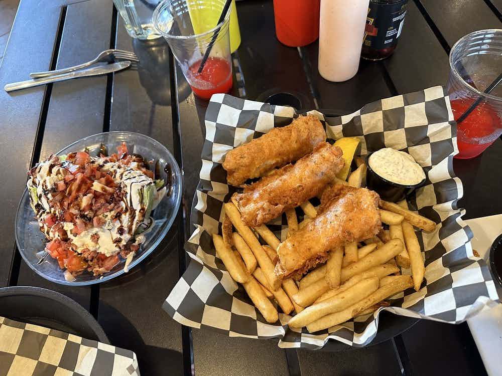 Housemade fish and chips and a wedge salad with bacon from the Snake River Roadhouse in Swan Valley, Idaho within the Yellowstone Teton Territory