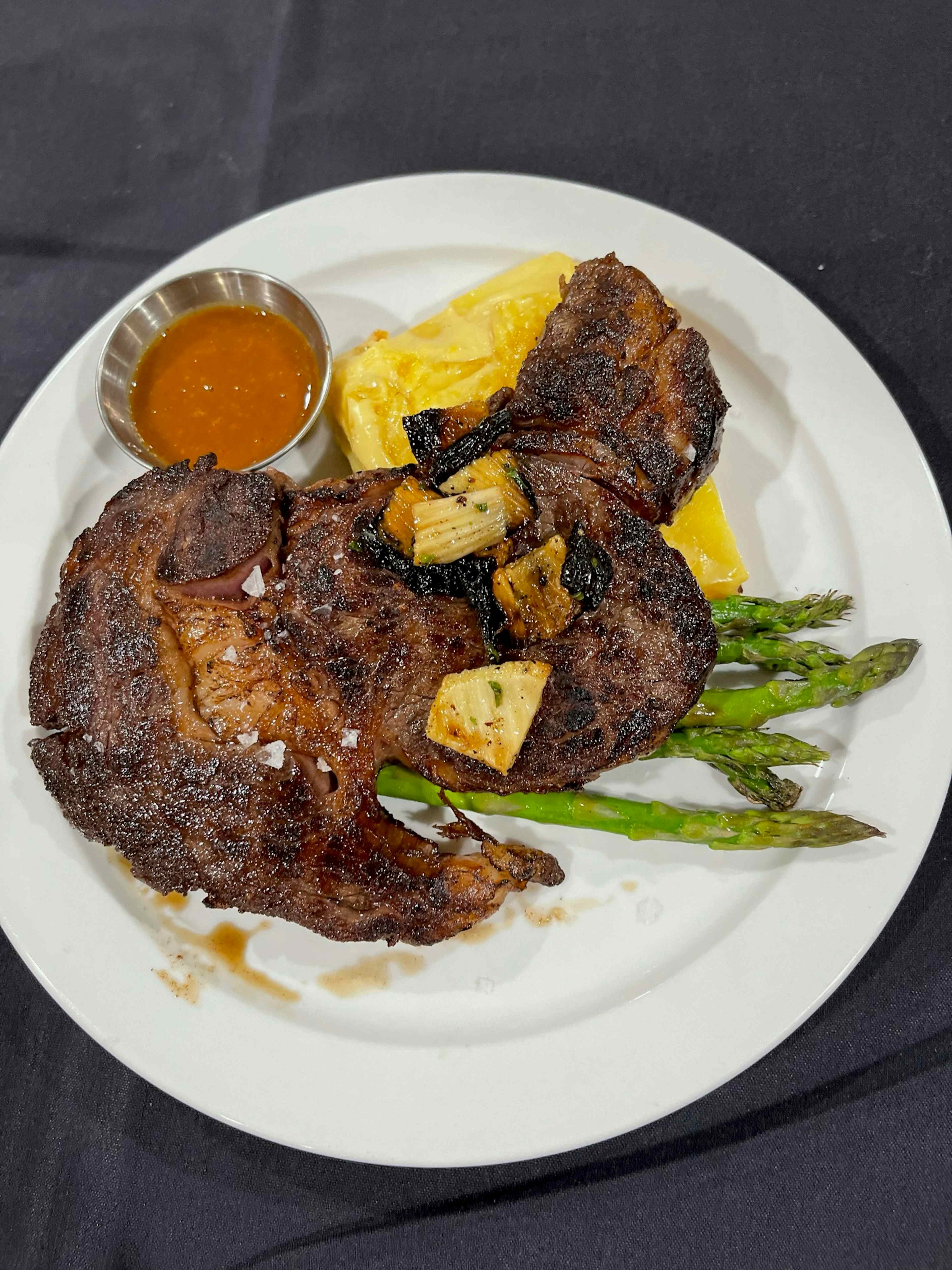 The Teton Valley Lodge in the Yellowstone Teton Territory offers an array of world-class meals, including the pictured perfectly-grilled steak atop a bed of asparagus